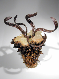 <div class='title'>Pelvic Twist</div><br>kiln-cast glass, seed pods, varnish, steel base, prismacolor<br>17"h x 13"w x 13"d<br>