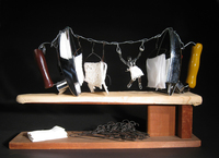 <div class='title'>Iron Woman</div><br>Flameworked figures, artist-wrought steel hangers, vintage irons and board, mirrors, fabric<br>14"w x 22"h x 5.5"d<br>SOLD