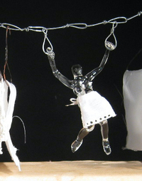 <div class='title'>Iron Woman</div><br>Flameworked figures, artist-wrought steel hangers, vintage irons and board, mirrors, fabric<br>14"w x 22"h x 5.5"d<br>SOLD