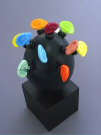 <div class='title'>I'm All Ears</div><br>Kiln cast glass, emu egg, pedestal <br><a href='videos/630.mov' target=_blank>VIDEO!</a> <br>9"w x 3"h x 3"l<br>