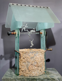 <div class='title'>Well Wishers</div><br>flameworked, fused and coldworked glass, mirror, soup pot, meat grinder handle, door knob, grass, weeds, zippers, eggshells, feathers, bones, tatting, flowers, leaves, copper, leather, rubber grommets<br>32"h x 23"w x 21"d<br>