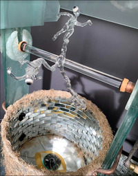 <div class='title'>Well Wishers</div><br>flameworked, fused and coldworked glass, mirror, soup pot, meat grinder handle, door knob, grass, weeds, zippers, eggshells, feathers, bones, tatting, flowers, leaves, copper, leather, rubber grommets<br>32"h x 23"w x 21"d<br>