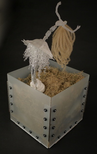 <div class='title'>Shaman's Rattle (Winter)</div><br>Flameworked, sheet and mirrored glass, plumber's putty, grass, metals, rubber grommets<br>18"h x 12"w x 12"d<br>