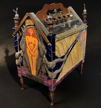 <div class='title'>Forward</div><br>Kiln-cast, flameworked, mirrored glass and sheet glass, metal and rubber findings, vintage magazine rack, fescue, sewing patterns<br>26"h x 14"w x 24"d<br>