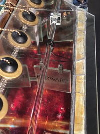 <div class='title'>Forward</div><br>Kiln-cast, flameworked, mirrored glass and sheet glass, metal and rubber findings, vintage magazine rack, fescue, sewing patterns<br>26"h x 14"w x 24"d<br>