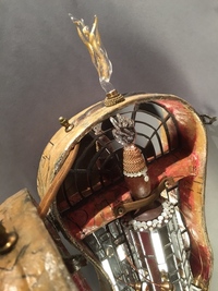 <div class='title'>Ancestral Tunes</div><br>flameworked glass, vintage violin case, mirror, vintage sewing patterns, mixed media. <br><a href='videos/644.mov' target=_blank>VIDEO!</a><br>35"h x 10"w x 4"d<br>