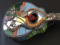 <div class='title'>Mandel-Inn</div><br>cast and flameworked glass, mandolin, mixed media <br>26"h x 10"w x 40"d<br>NFS