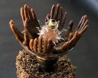 <div class='title'>Truckin'</div><br>flameworked vessel, eye and flowers,  cast wax hands, sheet glass,<br>toy truck, piano keys, vintage toaster, seed pods, moss, brass findings, found objects<br>20"h x 18"d x 17"w<br>NFS