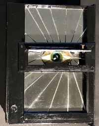 <div class='title'>Seeking Eternity</div><br>fused glass, mirror, found boxes, piano hinges, acrylics, found object (handle)<br><br>