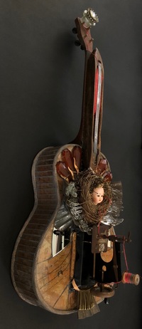 <div class='title'>Machinations</div><br>flameworked hands, guitar, seamstress tissue, sheet glass, mirror, vintage child's sewing machine, vintage wool shuttle, nest, bee hive, seeds, bundt pan, brass pins, watch-works, ruler, metal findings<br>43"h x 19"w x 12"d<br>