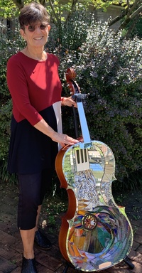 <div class='title'>Creation</div><br>flameworked eyes and white points on gear, cello, stained glass, mirror, piano keys, hand drill gear, grout<br>49"h x 21"w x 20"d<br>