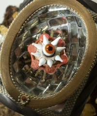 <div class='title'>Point the Way</div><br>Cast glass hand, flameworked/guilded flowers, flameworked eye and points, vintage toaster, vintage ice skates, silver chalice, mirror, vintage bundt pan, moss, found objects <br><a href='videos/658.mov' target=_blank>VIDEO!</a><br>14"h x 13"w x 14.5"d<br>