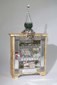 <div class='title'>Caged Bird</div><br>Flameworked vessel and eye, artist-painted enamel glass tile, sewing patterns, pen nibs, vintage buttons and bobbin, watch and jewelry parts, robin's egg, found objects<br>23"h x 11.5"w x 9"d<br>NFS